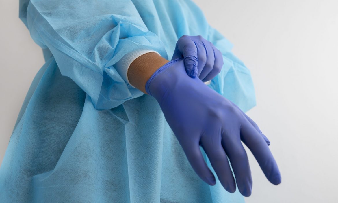 side-view-doctor-putting-glove